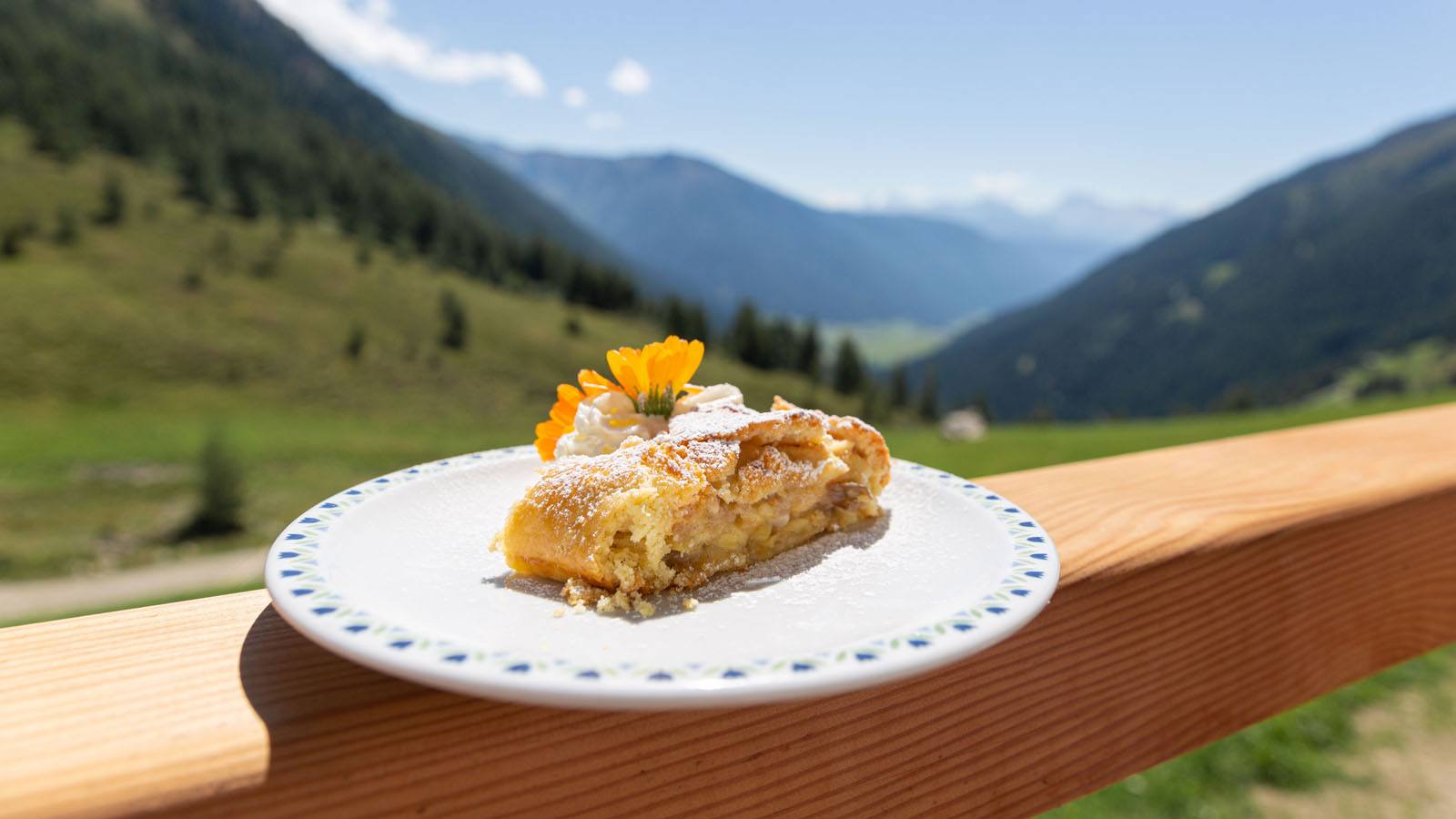a traditional apple strudel on the balcony of the Hotel Tyrol in Casies in summer